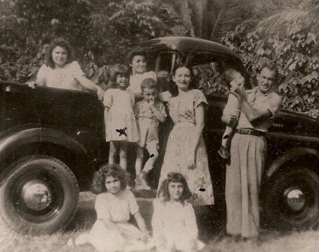 Pedro Juan and his family in Marueño,  He is standing on the right side of the photo holding one of his sons, beside his wife Carmen (Cambu) Gueits who has her arm around another one of their sons and Judith, their neice.  SItting in the foreground is my mother, Lily.  I don't know who is the other little girl.  Sitting in the back of the truck is Amparo batiz and the other young lady I don;t know. 